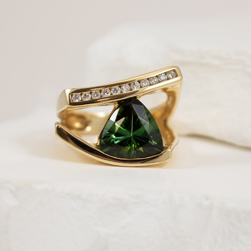 14KY Geometric Green Tourmaline & Diamond Ring     
14K Yellow Gold Green Tourmaline & Natural Diamond Ring
Trillion Cut Green Tourmaline
0.18 Total Natural Diamond Weight
Finger Size 7