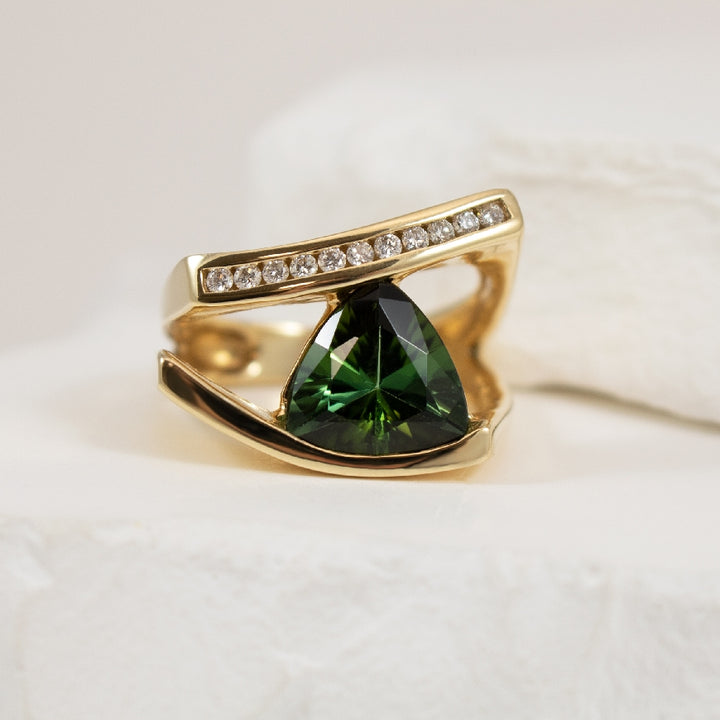 14KY Geometric Green Tourmaline & Diamond Ring     
14K Yellow Gold Green Tourmaline & Natural Diamond Ring
Trillion Cut Green Tourmaline
0.18 Total Natural Diamond Weight
Finger Size 7