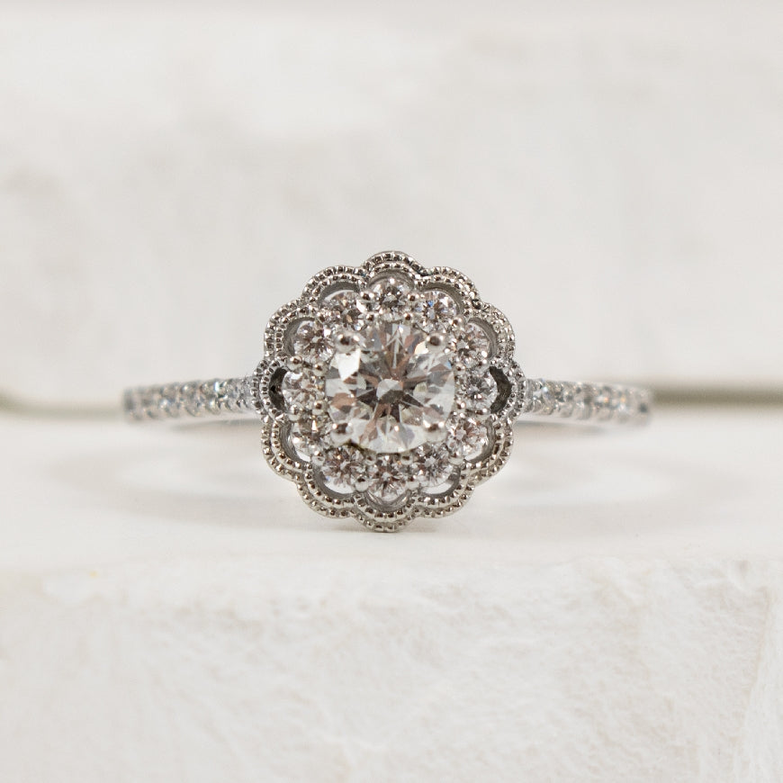 18KW Canadian Diamond Vintage Halo Engagement Ring
18K White Gold & Platinum Canadian Natural Diamond Halo Engagement Ring 
Center Diamond - 0.36 Carat Round Brilliant Cut Canadian Natural Diamond of SI2 Clarity, H Colour, Ideal Cut
Accent D