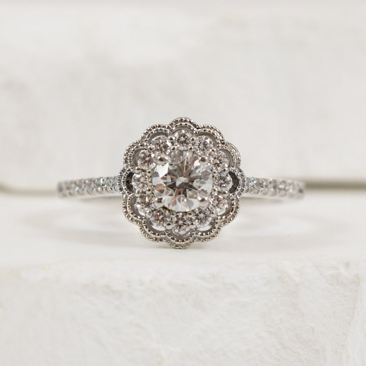 18KW Canadian Diamond Vintage Halo Engagement Ring
18K White Gold & Platinum Canadian Natural Diamond Halo Engagement Ring 
Center Diamond - 0.36 Carat Round Brilliant Cut Canadian Natural Diamond of SI2 Clarity, H Colour, Ideal Cut
Accent D