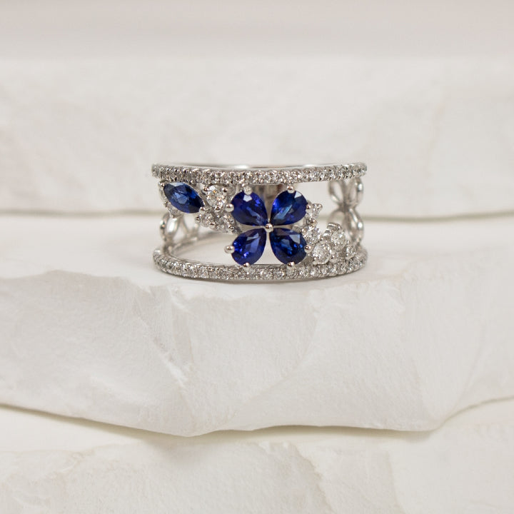 18KW Open Concept Floral Sapphire & Diamond Ring  
18K White Gold Sapphire & Natural Diamond Ring
0.90 Total Natural Sapphire Weight
0.50 Total Natural Diamond Weight SI1-VS2 Clarity, G Colour
Finger Size 6