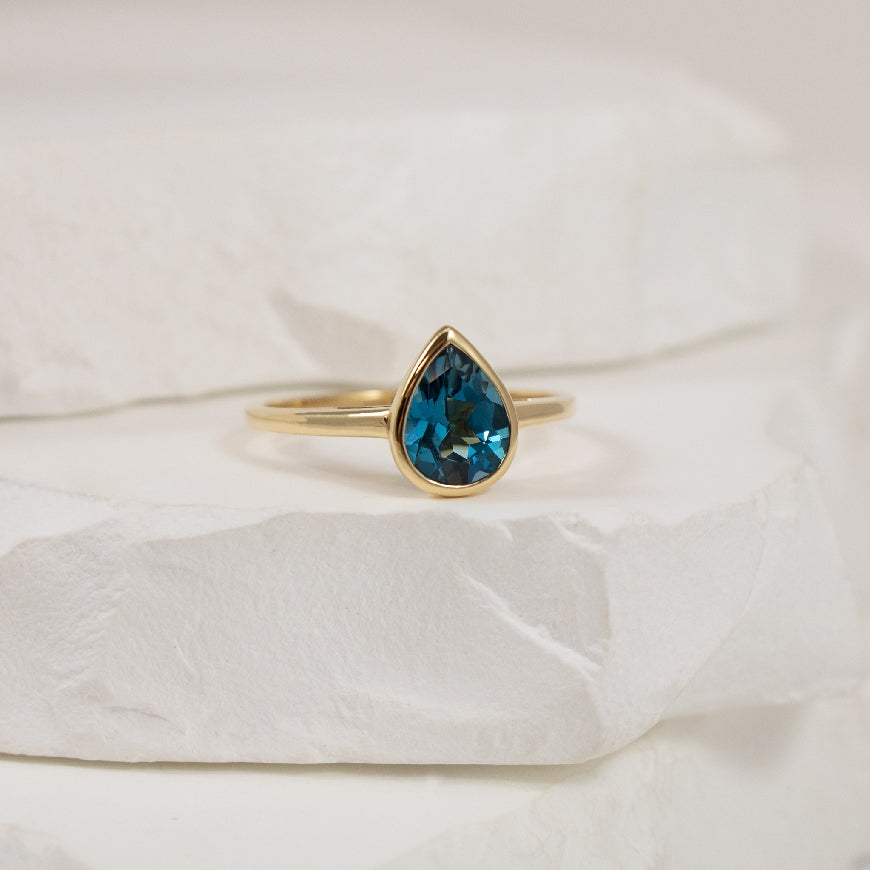 14KY Pear Shaped London Blue Topaz Bezel Set Ring
14K Yellow Gold London Blue Topaz Bezel Ring
1.08 Carat of Natural Pear Shaped Blue Topaz
Finger Size 7