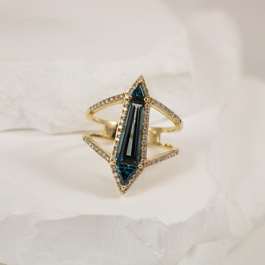 14KY Geometric London Blue Topaz & Diamond Ring    
14K Yellow Gold Bassali London Blue Topaz & Natural Diamond Ring
2.45 Total Natural Blue Topaz Weight
0.37 Total Natural Diamond Weight
Finger Size 8.5