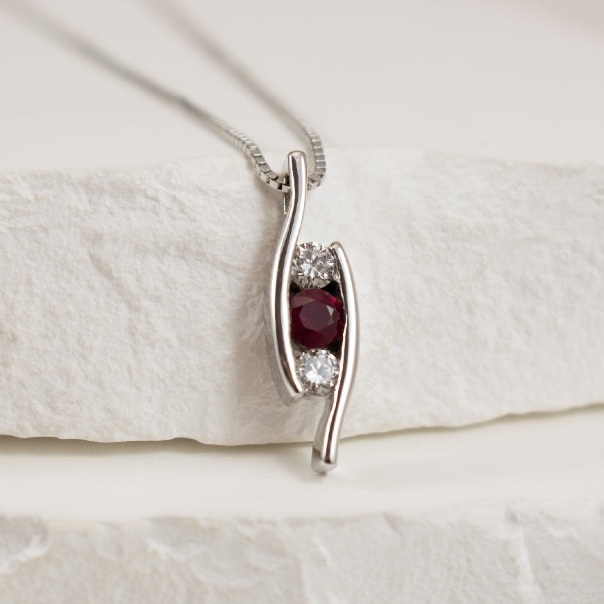 14KW Three Stone Ruby & Diamond Necklace
14K White Gold Three Stone Ruby & Diamond Necklace
0.22 Total Ruby Weight
0.18 Total Natural Diamond Weight of SI Clarity, GH Colour
Chain Length 16'