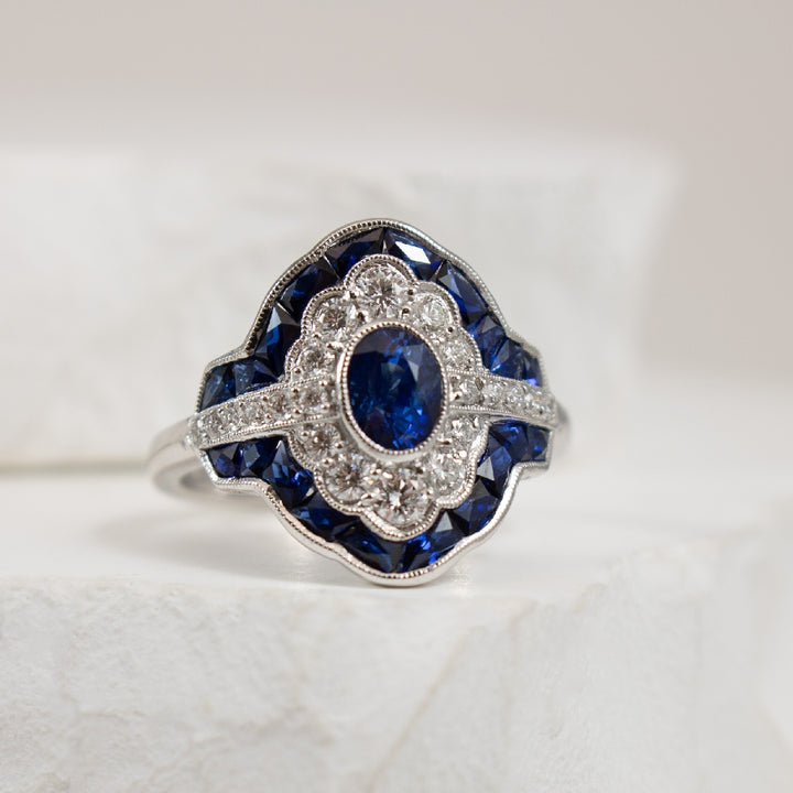 14KW Sapphire & Diamond Vintage Inspired Ring     
14K White Gold Sapphire & Natural Diamond Ring
1.99 Total Sapphire Weight
0.45 Total Natural Diamond Weight of SI1 Clarity, H Colour
Finger Size