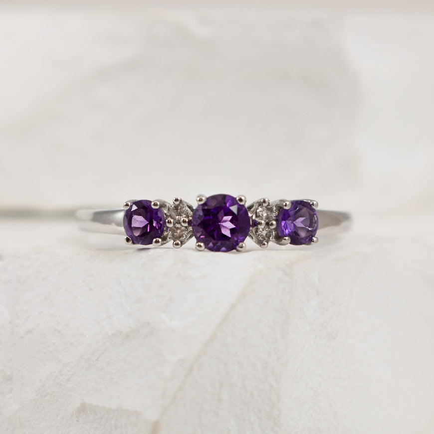 10KW Amethyst & Diamond Trinity Ring
10K White Gold Amethyst & Diamond Trinity Ring
0.35 Total Natural Diamond Weight
4mm & 2mm Amethysts
Finger Size