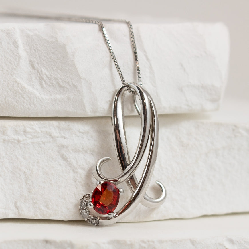 14KW Red/Orange Sapphire Necklace
14K White Gold Red/Orange Sapphire & Diamond Necklace
0.05 Total Natural Diamond Weight of I1 Clarity, GH Colour
Chain Length 18'