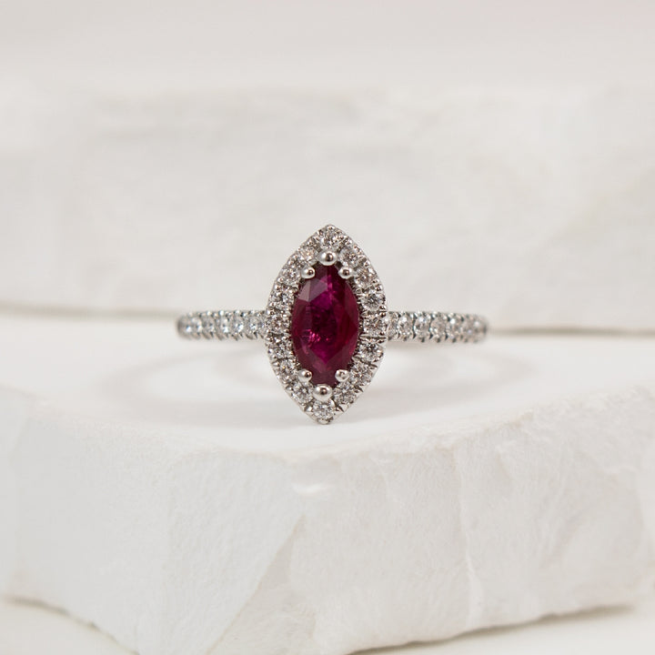 18KW Marquise Cut Ruby & Diamond Halo Ring        
18K White Gold Marquise Cut Ruby & Natural Diamond Halo Ring
0.55 Carat Marquise Cut Ruby
0.29 Total Natural Diamond Weight of SI1-2 Clarity, GH Colour
Finger Size 6.5