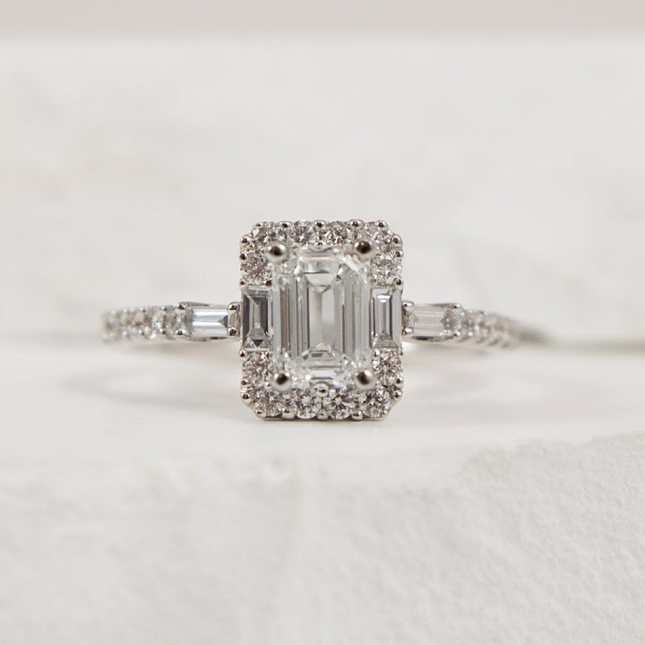 14KW Emerald Cut Halo Diamond Engagement Ring     
14K White Gold Canadian Natural Diamond Emerald Cut Halo Engagement Ring 
Center - 0.90 Carat Emerald Cut Canadian Natural Diamond of VS1 Clarity, H Colour, Very Good Cut 
 
Accent - 0.45 Car
