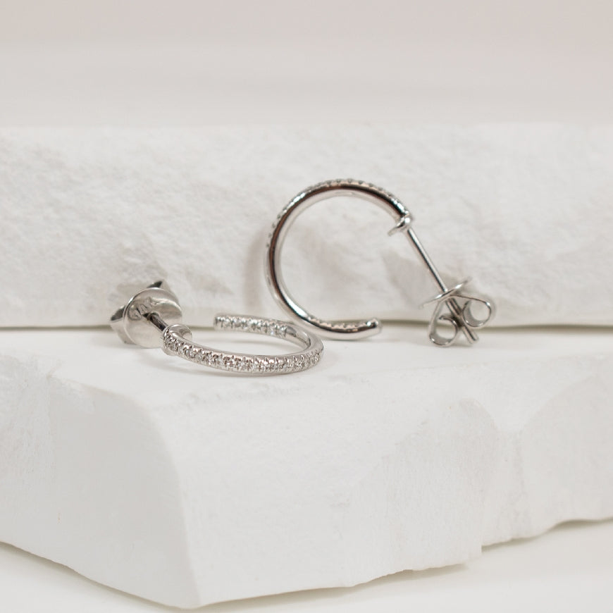 14KW Petite Diamond Post Hoop Earrings             
14K White Gold Roman & Jules Natural Diamond Hoop Earrings
0.10 Total Natural Diamond Weight SI Clarity, GH Colour
Earring Closure Post with Butterfly Back