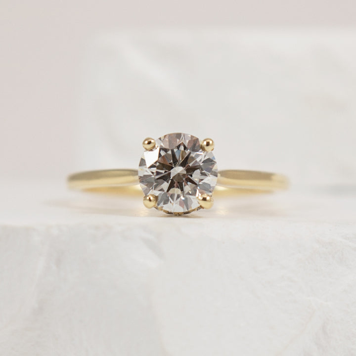 14KY S.Kashi Hidden Halo Diamond Engagement Ring  
14K Yellow Gold S.Kashi Forevermark Natural Diamond Solitaire & Hidden Halo Engagement Ring 
Center - 1.00 Carat Round Brilliant Cut Forevermark Natural Diamond of SI2 Clarity, H Colour, Excell