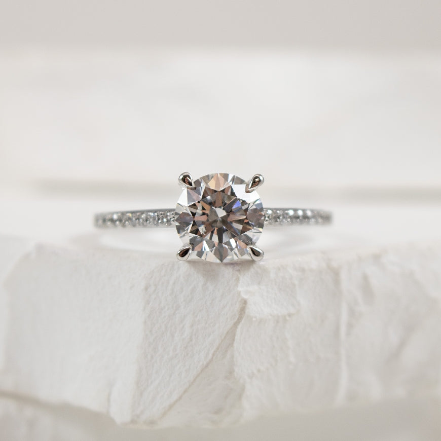 14KW 1.56CT Diamond Accented Engagement Ring      
14K White Gold Lab Grown Diamond Accented Engagement Ring 
Center - 1.56 Carat Round Brilliant Cut Lab Grown Diamond of SI2 Clarity, D Colour, Ideal Cut
Accent - 0.20 Carats Lab Grown Diamon