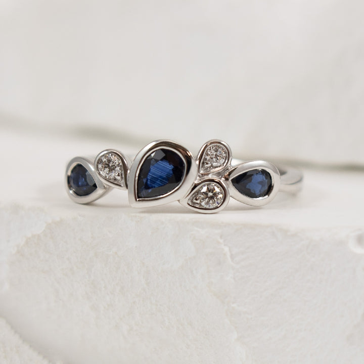 14KW Pear Shaped Bezel Sapphire & Diamond Ring   
14K White Gold Sapphire & Natural Diamond Ring
0.73 Total Sapphire Weight
0.08 Total Natural Diamond Weight
Finger Size 6.5