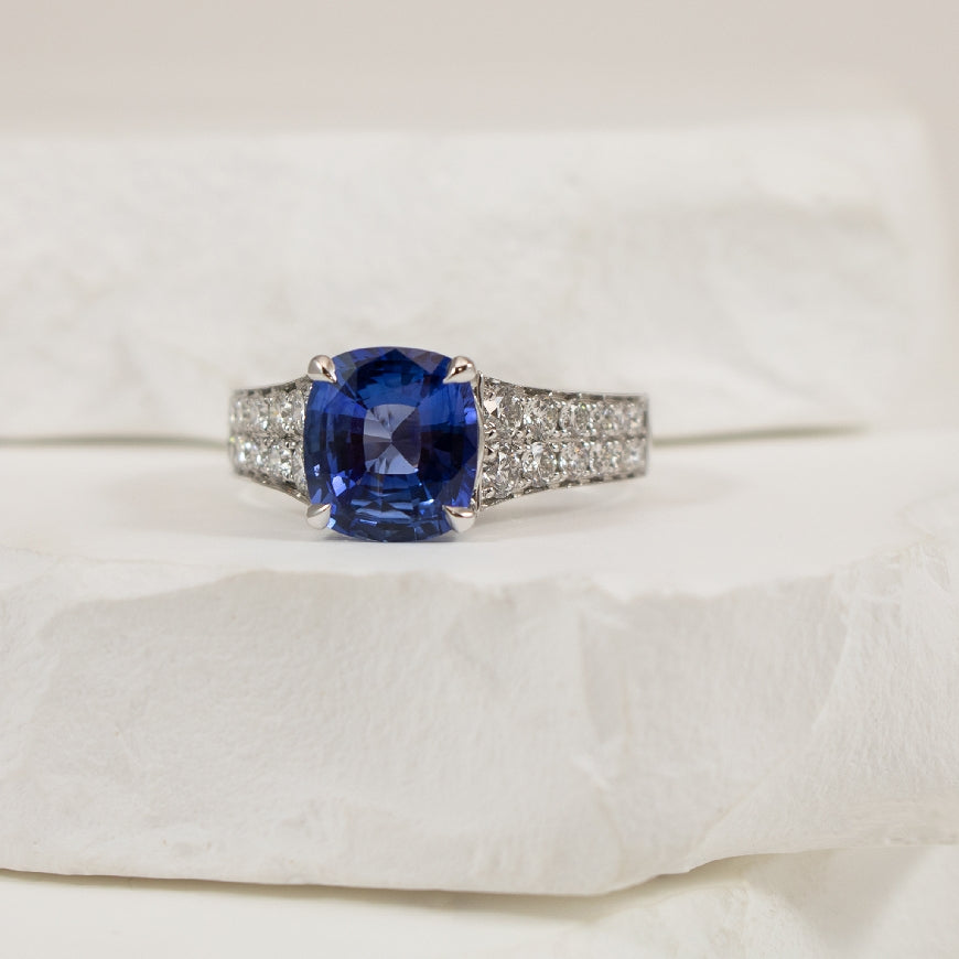 14KW 3.05CT Cushion Cut Sapphire & Diamond Ring  
14K White Gold Roman & Jules Sapphire & Natural Diamond Ring
3.05 Carat of Natural Cushion Cut Sapphire Eye-Clean 'Medium Tone Bright Violetish Blue'
0.82 Total Natural Diamond Weight VS1-2 C