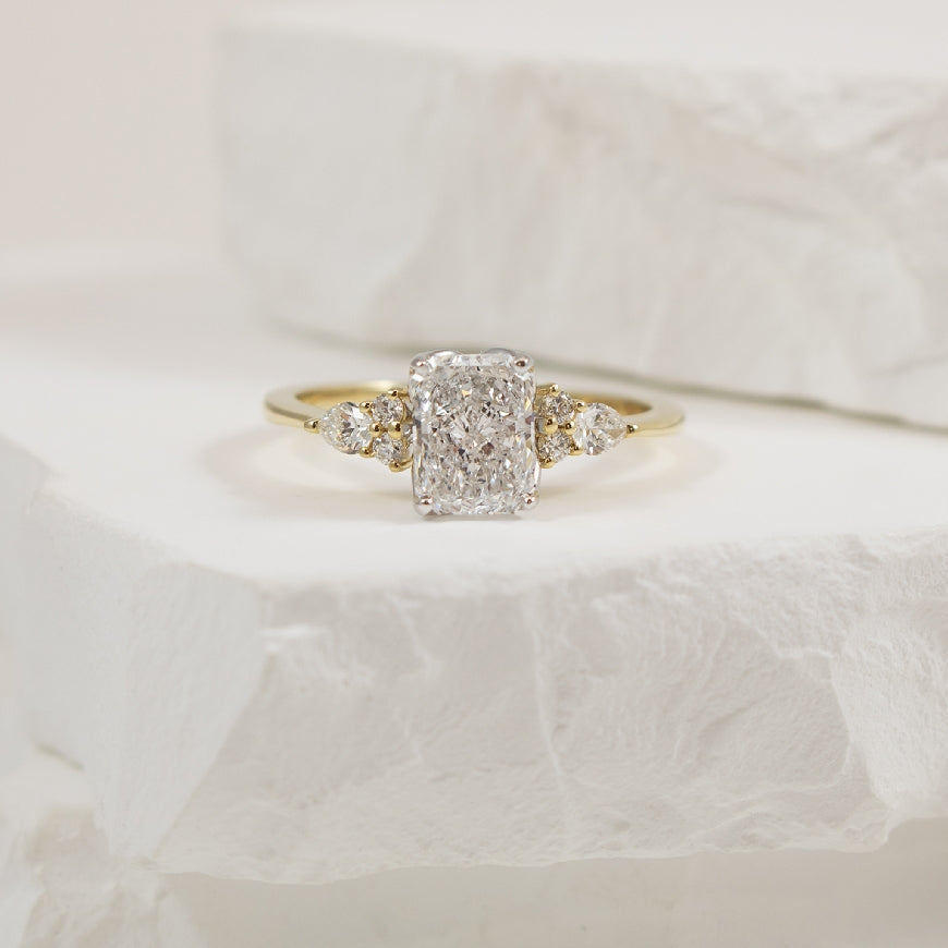 14KY Radiant & Multi Shape Diamond Engagement Ring
14K Yellow Gold Lab Gornw & Natural Diamond Multi Shape Engagement Ring
Center - 1.01CT Radiant Cut Lab Grown Diamond of VVS2 Clarity, E Colour, Excellent/ Excellent Cut, IGI Certified
 
Acce