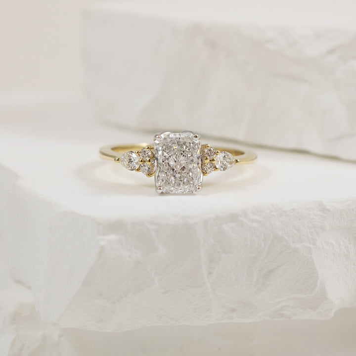 14KY Radiant & Multi Shape Diamond Engagement Ring
14K Yellow Gold Lab Gornw & Natural Diamond Multi Shape Engagement Ring
Center - 1.01CT Radiant Cut Lab Grown Diamond of VVS2 Clarity, E Colour, Excellent/ Excellent Cut, IGI Certified
 
Acce