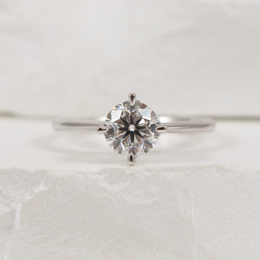 14KW East West Solitaire Diamond Engagement Ring  
14K White Gold Lab Grown Diamond Round Brilliant Cut Solitaire Engagement Ring 
Center - 1.01 Carat Round Brilliant Cut Lab Grown Diamond of VS2 Clarity, E Colour, Very Good Cut 
Finger Size