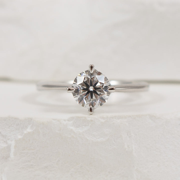 14KW East West Solitaire Diamond Engagement Ring  
14K White Gold Lab Grown Diamond Round Brilliant Cut Solitaire Engagement Ring 
Center - 1.01 Carat Round Brilliant Cut Lab Grown Diamond of VS2 Clarity, E Colour, Very Good Cut 
Finger Size
