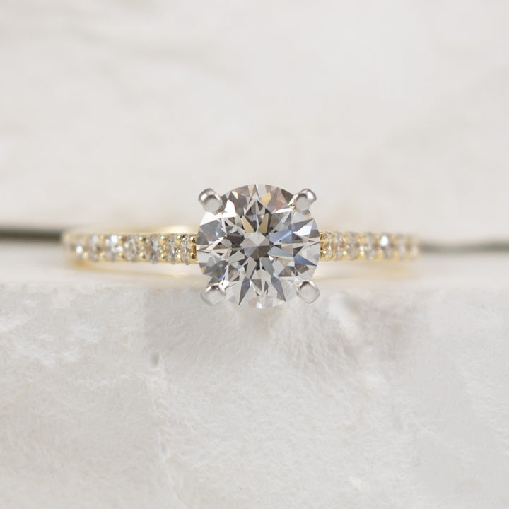 14KY Gabriel & Co 1.00CT Diamond Engagement Ring  
14K Yellow Gold Gabriel & Co. Lab Grown & Natural Diamond Accented Engagement Ring 
 
Center - 1.00 Carat Round Brilliant Cut Lab Grown Diamond of VS+ Clarity, G-I Colour, Very Good Cut 
 
Acc