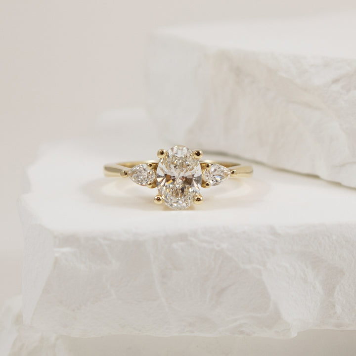 14KY Oval & Pear Trinity Diamond Engagement Ring  
14K Yellow Gold Lab Grown Diamond Three Stone Engagement Ring 
Center - 1.02CT Oval Cut Lab Grown Diamond of VS1 Clarity, F Colour, Excellent/ Excellent/ Excellent Cut, GCAL Certified 
Accen