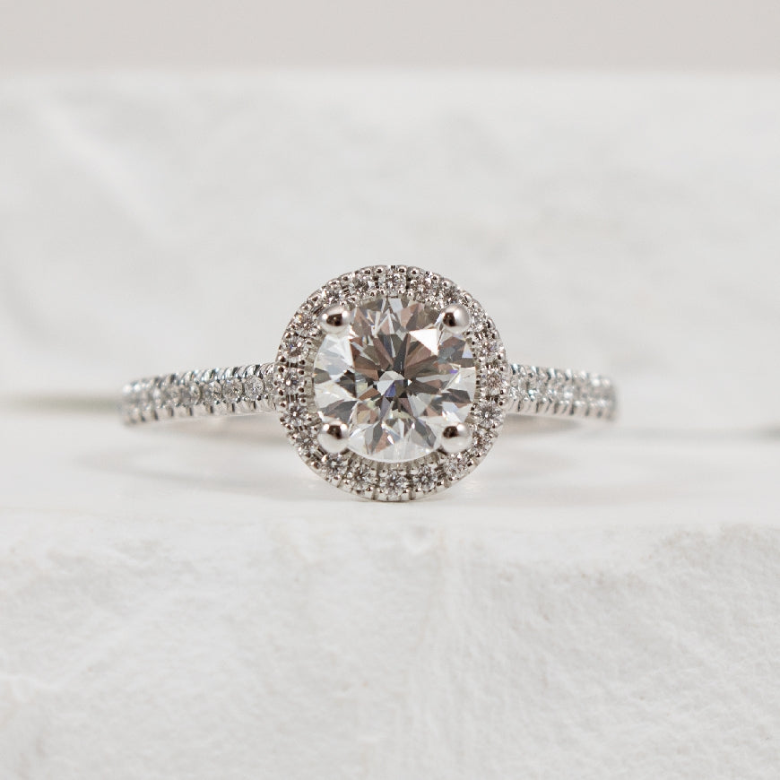 14KW Naledi Halo 0.90CT Diamond Engagement Ring  
14K White Gold Naledi Natural Round Diamond Halo Ring 
Center - 0.90 Carat Round Brilliant Cut Natural Diamond   VS2 Clarity, G Colour, Excellent/ Excellent/ Excellent Cut, GIA Certified 
Acc
