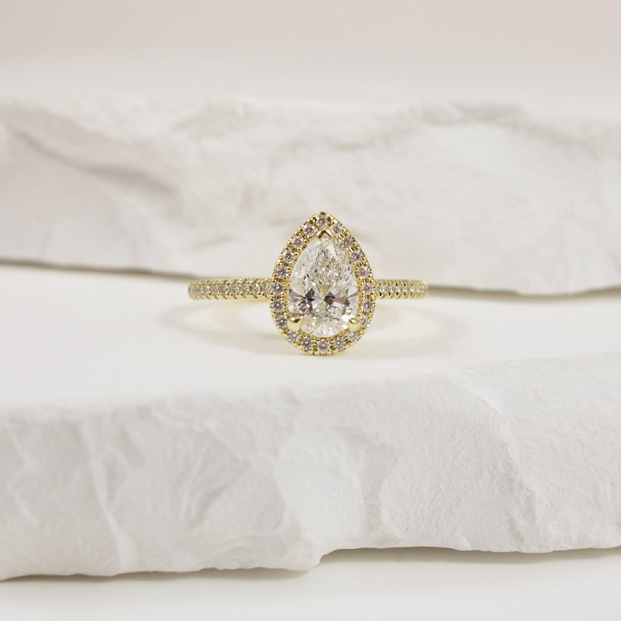 14KY Naledi 1CT Pear Halo Diamond Engagement Ring
14K Yellow Gold Naledi Pear Natural Diamond Halo Engagement Ring 
Center Diamond - 1.00 Carat Pear Shaped Lab Grown Diamond of  VS2 Clarity, D Colour, Excellent/ Very Good Cut, GIA Certified