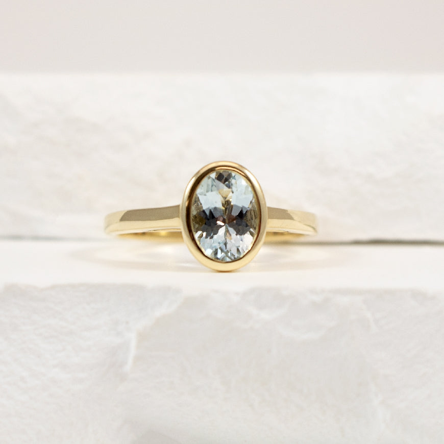 14KY Modern Oval Cut Aquamarine Bezel Set Ring   
14K Yellow Gold Aquamarine Bezel Ring
0.97 Carat of Natural Oval Cut Aquamarine
Finger Size 7