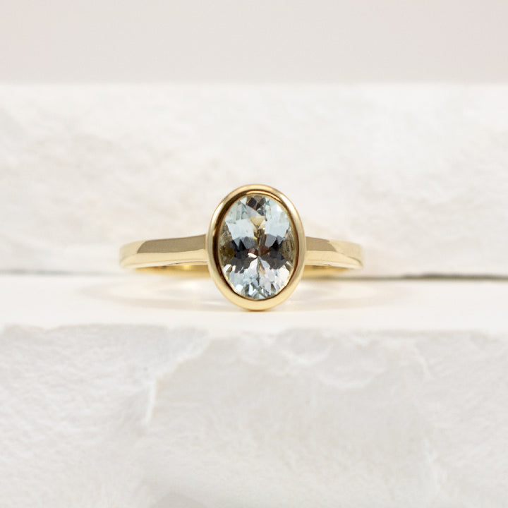 14KY Modern Oval Cut Aquamarine Bezel Set Ring   
14K Yellow Gold Aquamarine Bezel Ring
0.97 Carat of Natural Oval Cut Aquamarine
Finger Size 7