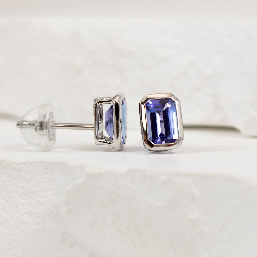 14KW Emerald Cut Bezel Set Tanzanite Earrings
14K White Gold Tanzanite Bezel Earrings
1.20 Total Natural Emerald Cut Tanzanite Weight
Earring Closure Post with Butterfly Back