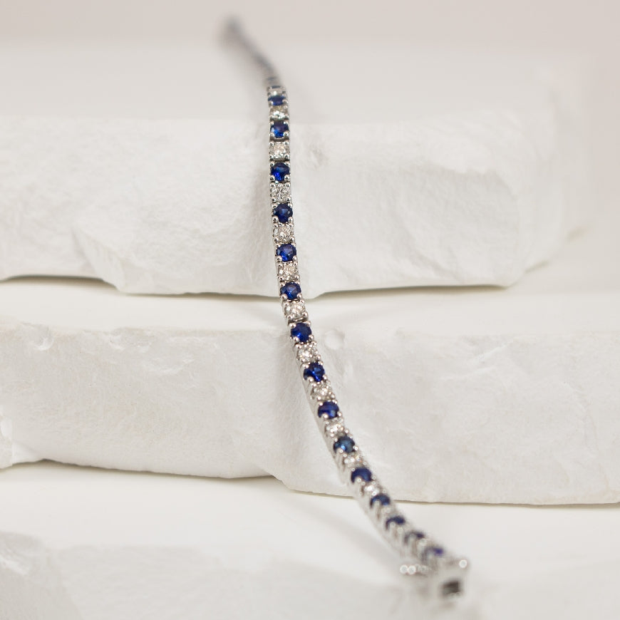 14KW 2.25CT Sapphire & Diamond Tennis Bracelet    
14K White Gold Roman & Jules Natural Diamond & Sapphire Tennis Bracelet 
1.25 Total Sapphire Weight 
1.00 Total Natural Diamond Weight SI1-2 Clarity, G-H Colour 
Bracelet Length 8'