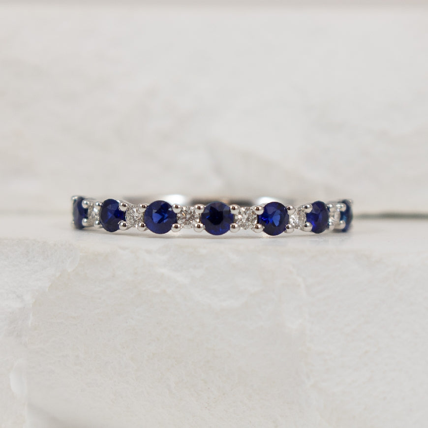 14KW Roman & Jules Classic Sapphire & Diamond Band
14K White Gold Roman & Jules Natural Diamond & Sapphire Band
0.46 Carats Round Sapphires 
0.08 Carats Round Brilliant Cut Natural Diamonds of SI1-2 Clarity, G-H Colour 
Size 6.5
