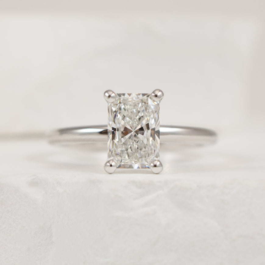 14KW 1.50CT Solitaire Diamond Engagement Ring         
14K White Gold Gabriel & Co. Lab Grown Solitaire Diamond Engagement Ring  
Center - 1.50CT Radiant Cut Lab Grown Diamond of VVS2 Clarity, E Colour, Excellent/ Excellent Cut 
S1950971