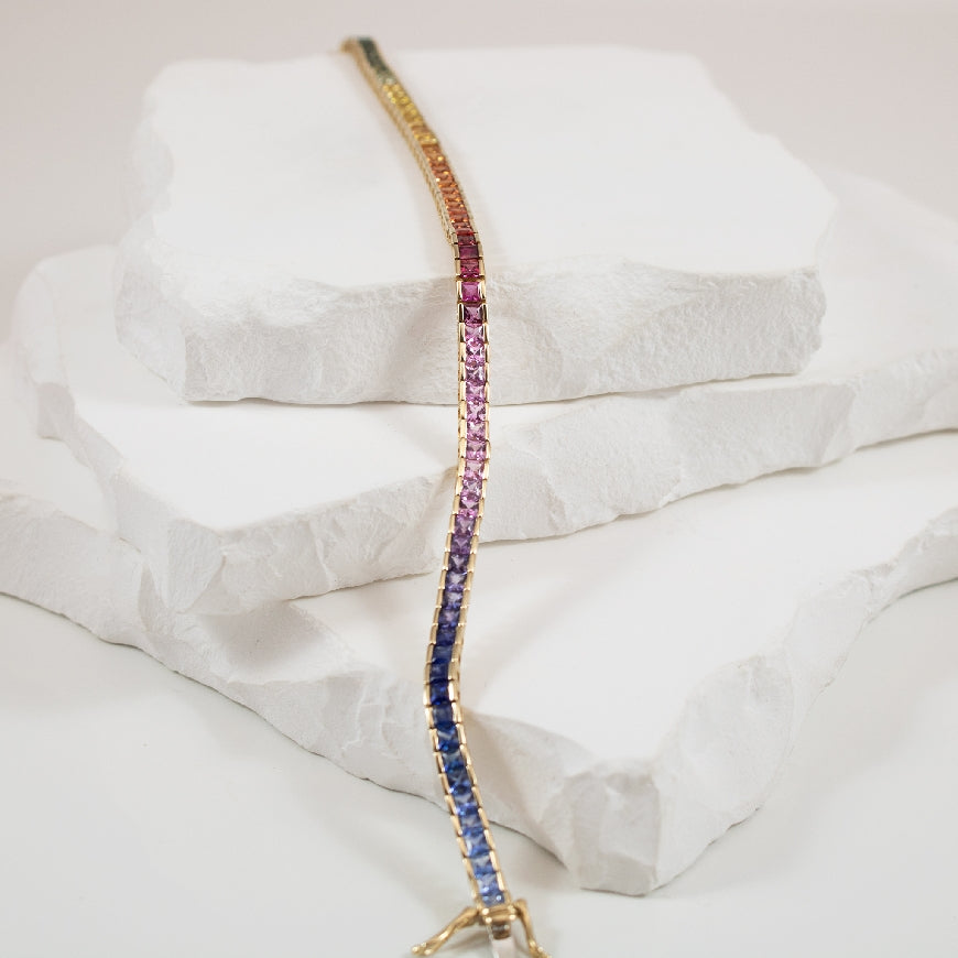14KY 7.20 Carat Rainbow Sapphire Tennis Bracelet  
14K Yellow Gold Rainbow Sapphire Tennis Bracelet 
7.20 Carat Assorted Sapphires (2.5mm) 
Bracelet Length 7.5'