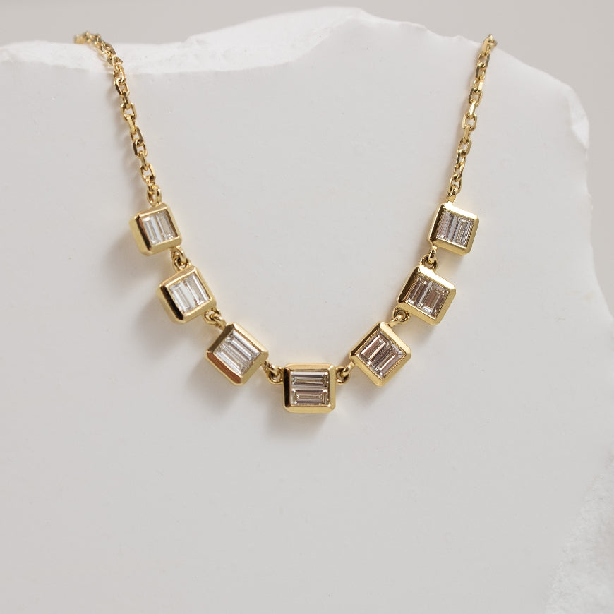 14KY Baguette Cut Bezel Diamond Necklace
14K Yellow Gold Baguette Cut Natural Diamond Bezel Set 7 Station Necklace
0.42 Carats Total Natural Diamond Weight of S11-2 Clartiy, G-H Colour
17' Adjustable Chain Length