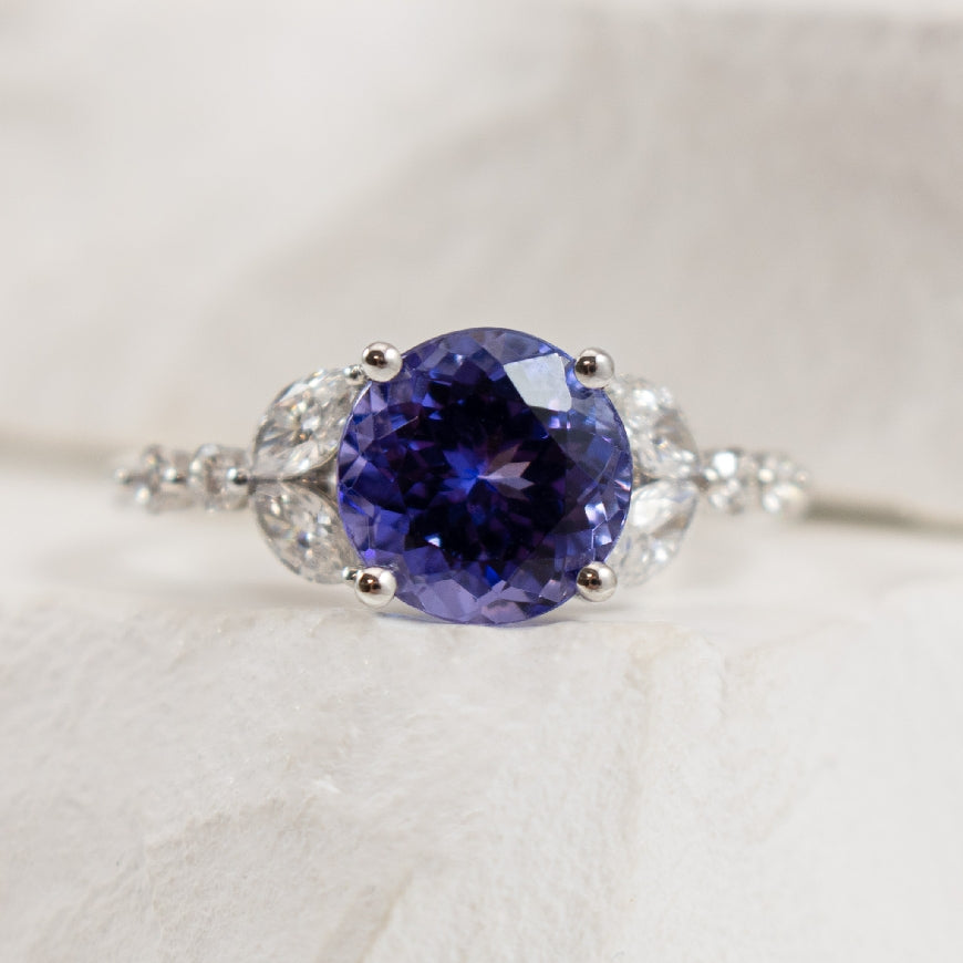 14KW S.Kashi 2.45CT Tanzanite & Diamond Ring  
14K White Gold S.Kashi Tanzanite & Marquise Cut Diamond Ring 
2.45 Carat Round Cut Tanzanite
0.51 Total Diamond Weight SI1-2 Clarity, GH Colour 
Finger Size 6.5