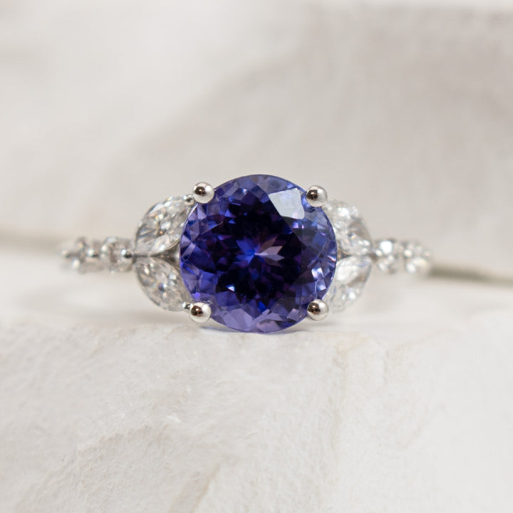 14KW S.Kashi 2.45CT Tanzanite & Diamond Ring  
14K White Gold S.Kashi Tanzanite & Marquise Cut Diamond Ring 
2.45 Carat Round Cut Tanzanite
0.51 Total Diamond Weight SI1-2 Clarity, GH Colour 
Finger Size 6.5