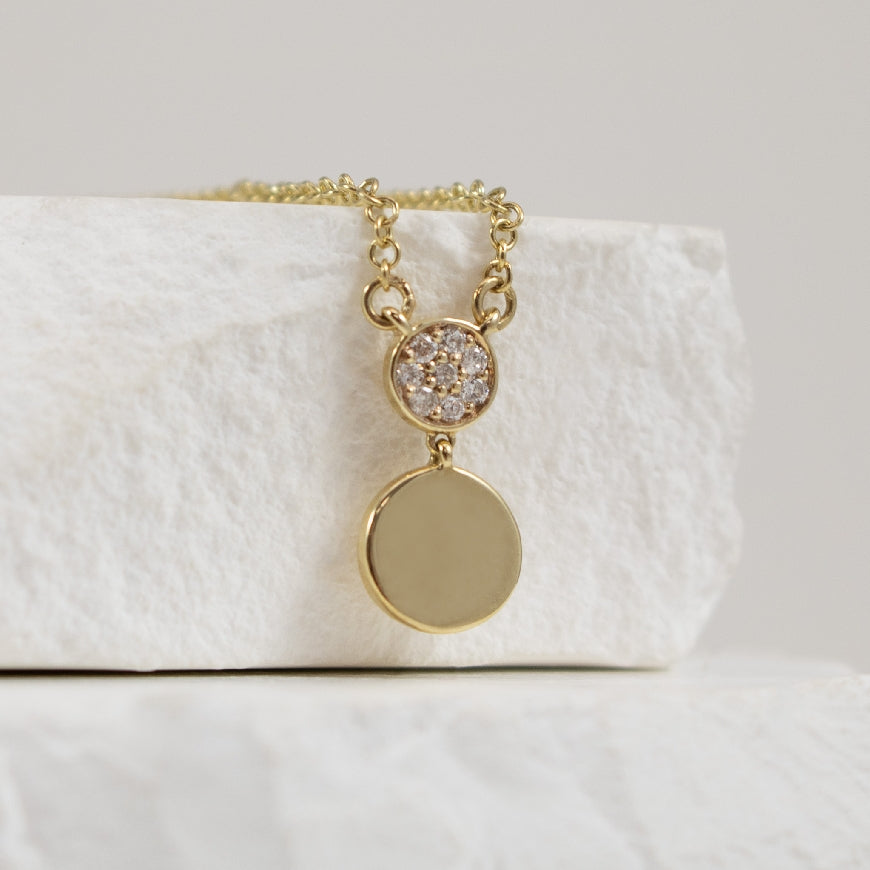10KY Petite Diamond Double Disc Necklace
10K Yellow Gold Natural Diamond Double Disc Necklace
0.04 Total Natural Diamond Weight of I2 Clarity, HIJ Colour
Chain Length 18'