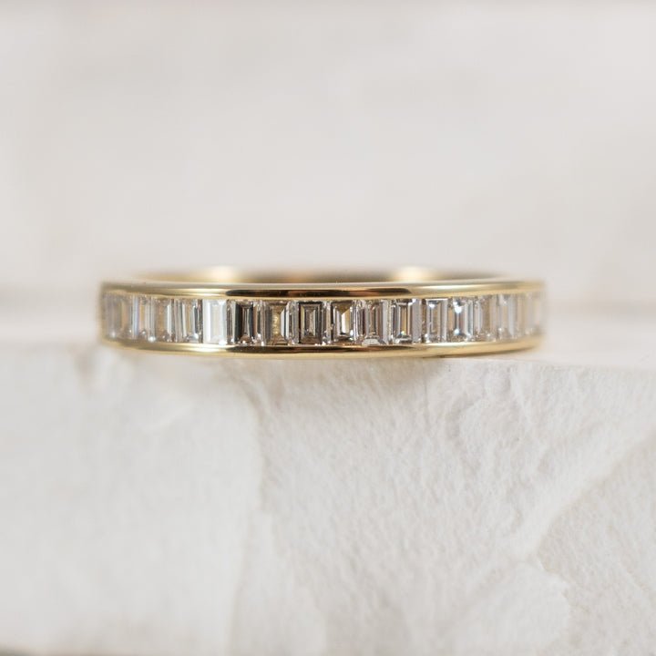 14KY Baguette Cut Diamond Channel Band 
14K Yellow Gold Baguette Cut Diamond Channel Set Band 
0.65 Total Diamond Weight of SI2-I1 Clarity, GHI Colour 
Finger Size 6.5