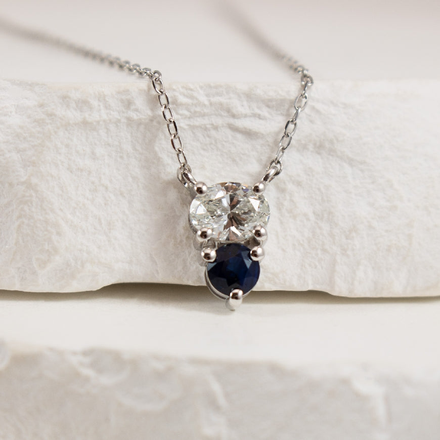 14KW Two Stone Sapphire & Diamond Necklace    
14 Karat White Gold Natural Round Sapphire & Oval Lab Grown Diamond Two Stone Necklace 
0.50 Carat Oval Cut Lab Grown Diamond of VS Clarity, F Colour 
0.25 Carat Round Cut Natural Blue Sapphire