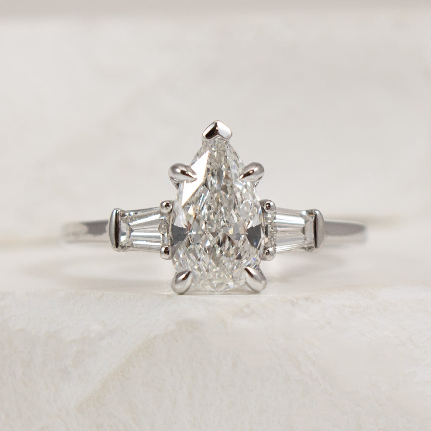 14KW Gabriel & Co. Diamond Engagement Ring           

14 Karat White Gold Gabriel & Co. Lab Grown Diamond Three Stone Pear Shaped Engagement Ring 

Center - 1.51 Carat Pear Shaped Lab Grown Diamond of VS1 Clarity, D Colour, Excellent/ Excellent 