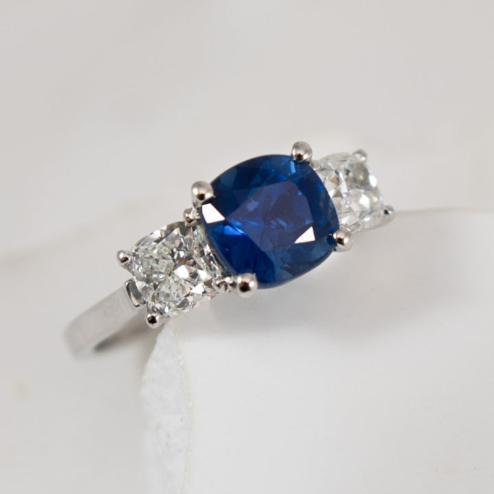 Platinum Sapphire & Canadian Diamond Ring 

Platinum Natural Cushion Cut Sapphire & Maple Leaf Canadian Diamond Three Stone Ring

2.21 Carat of Natural Cushion Cut Sapphire 

1.21 Carats Total Natural Canadian Diamond Weight SI2-I1 Clarity, D-F