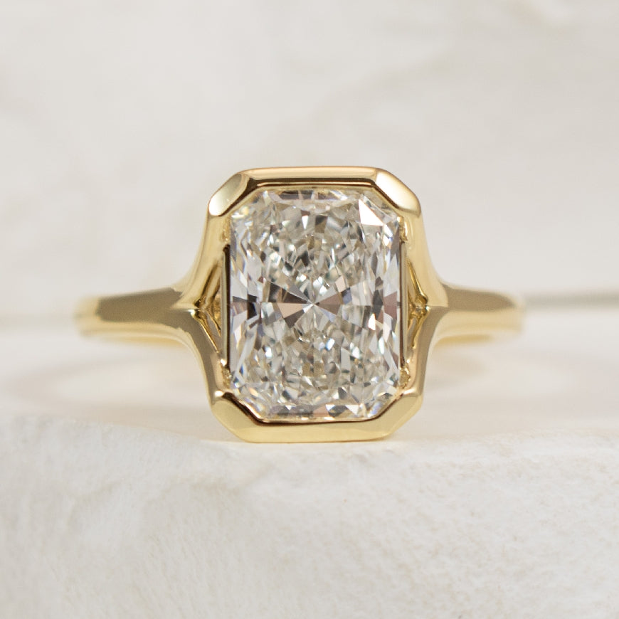 14KY Gabriel & Co. Diamond Engagement Ring           

14 Karat Yellow Gold Gabriel & Co. Lab Grown Radiant Cut Diamond Half-Bezel Engagement Ring 

Center - 2.54 Carat Radiant Cut Lab Grown Diamond of VVS2 Clarity, E Colour, Excellent/ Excellent