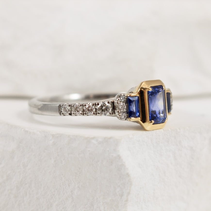Two Tone Bezel Set Emerald Cut Sapphire and Diamond Accented Ring