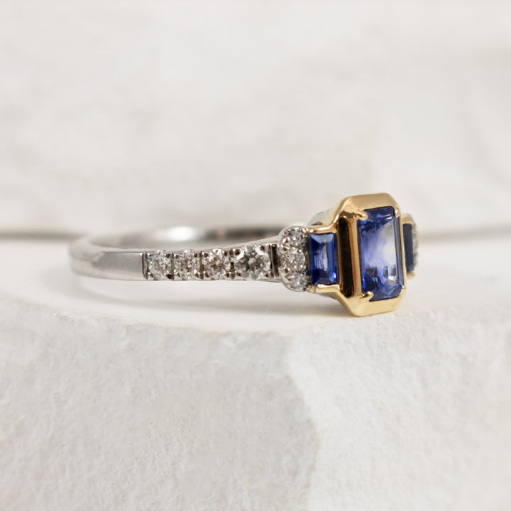 Two Tone Bezel Set Emerald Cut Sapphire and Diamond Accented Ring