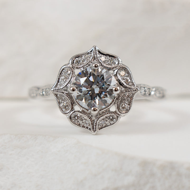 14K White Gold Lab Grown Fancy Blue Diamond Vintage Halo Engagement Ring 

Center - 0.75 Carat Fancy Blue Lab Grown Diamond of VVS2 Clarity, Ideal/ Excelllent/ Excellent Cut, IGI Certified 

Accent - 0.13 Total Natural Diamond Weight of SI1 Clari