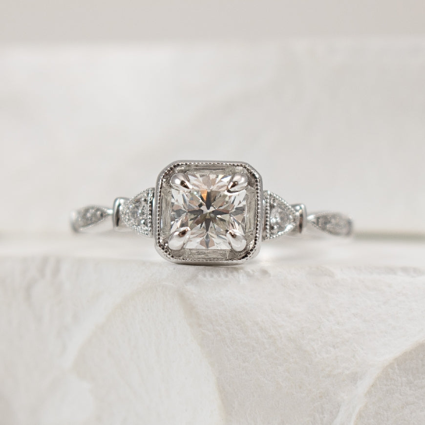 18KW Forevermark Diamond Accented Engagement Ring 

18K White Gold Forevermark Natural Diamond Vintage Accented Engagement Ring 

Center - 0.71 Carat Princess Cut Forevermark Diamond of SI2 Clarity, G Colour, Black Label Cut Forevermark

Accent