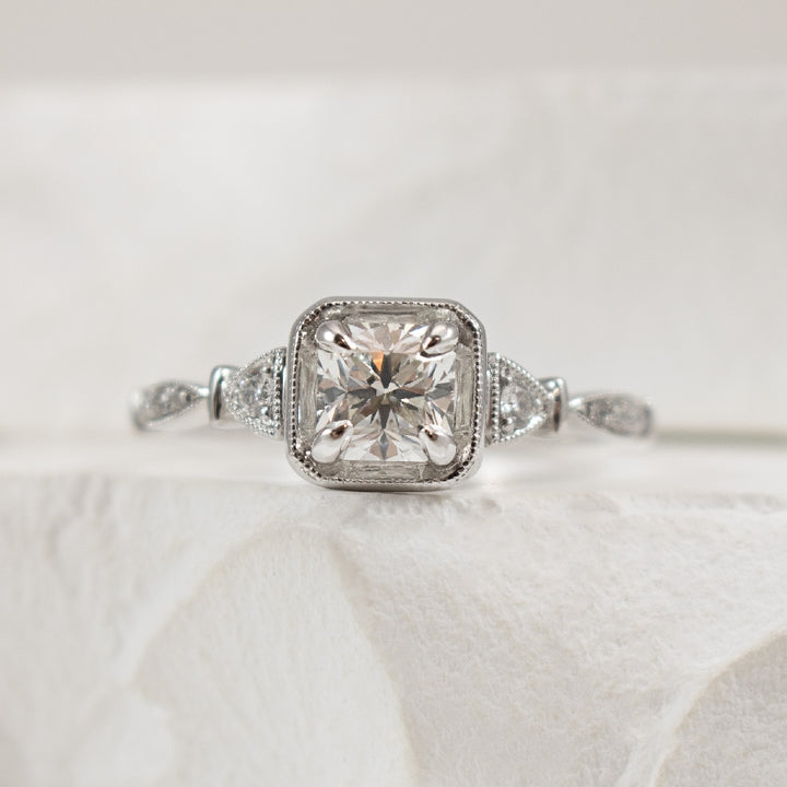 18KW Forevermark Diamond Accented Engagement Ring 

18K White Gold Forevermark Natural Diamond Vintage Accented Engagement Ring 

Center - 0.71 Carat Princess Cut Forevermark Diamond of SI2 Clarity, G Colour, Black Label Cut Forevermark

Accent