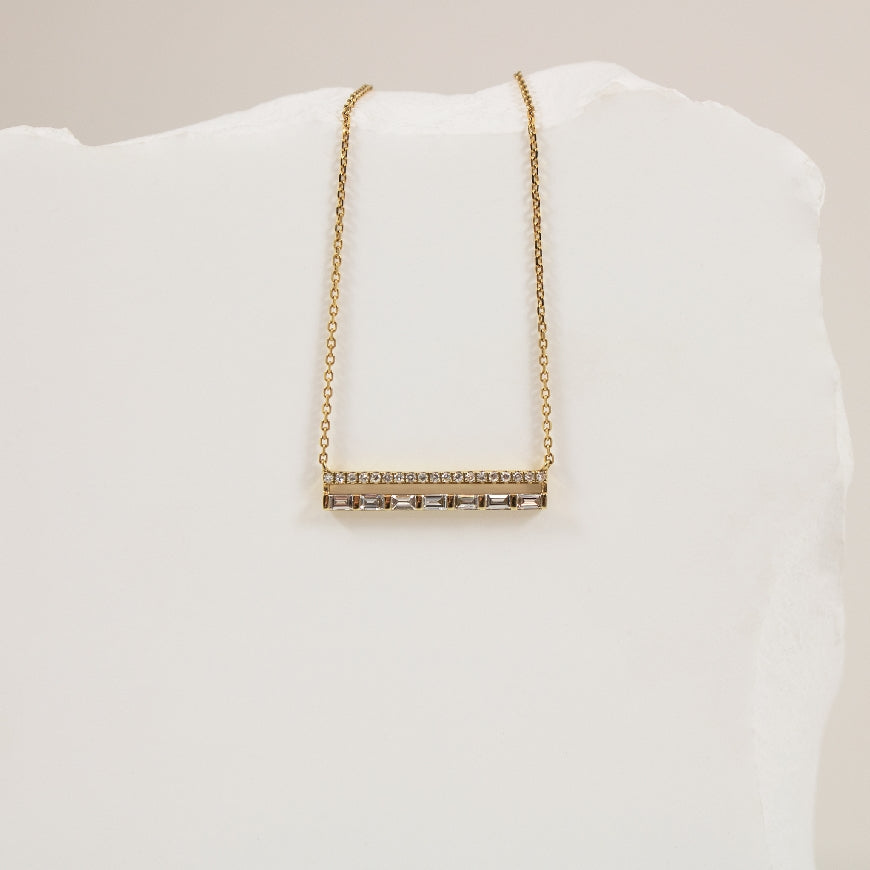 14KY Bassali Horizontal Baguette Bar Necklace          

14K Yellow Gold Bassali Natural Diamond Necklace 

0.16 Total Baguette Cut Diamond Weight
0.06 Total Round Brilliant Cut Diamond Weight
0.22 Total Natural Diamond Weight

Chain Length 1