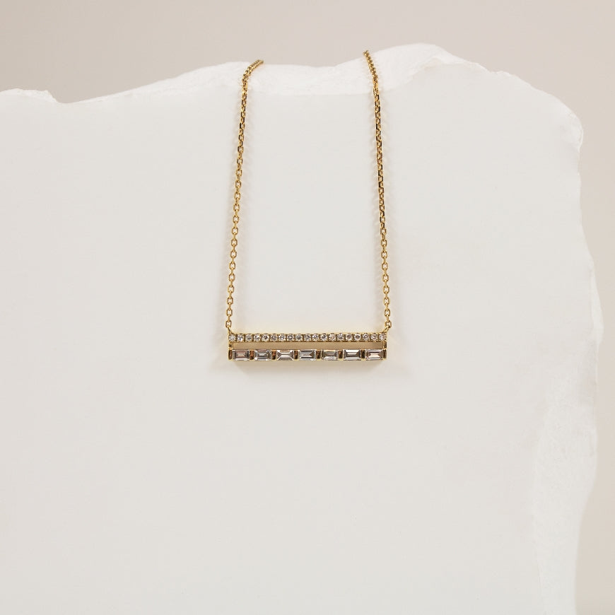 14KY Bassali Horizontal Baguette Bar Necklace          

14K Yellow Gold Bassali Natural Diamond Necklace 

0.16 Total Baguette Cut Diamond Weight
0.06 Total Round Brilliant Cut Diamond Weight
0.22 Total Natural Diamond Weight

Chain Length 1