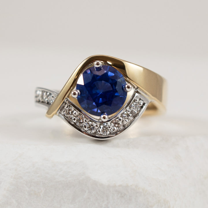 14KW/Y Sapphire & Diamond Asymetrical Ring 

14K Yellow & White Gold Sapphire & Diamond Asymetrical Ring 

1.46 Carat Ceylon Sapphire Medium Strong Very Slightly Violet Blue, Eye-Clean, Exceptional Cut 

0.17 Total Diamond Weight of SI1-2 Calri